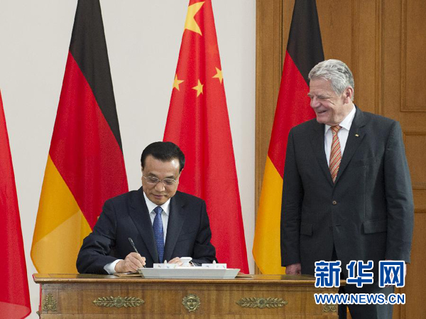 10月10日，國務院總理李克強在柏林會見德國總統高克。這是李克強總理在高克總統的陪同下在貴賓簿上簽字。 新華社記者 王曄 攝 